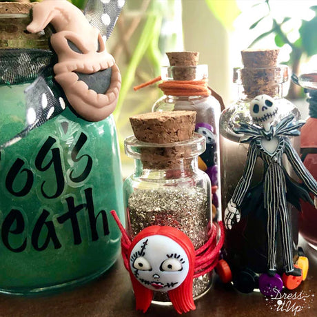 nightmare before christmas embellishments on a craft project of glass jars