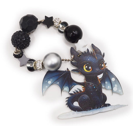 Assortment of silicone black and white dragon themed beads with charms. 