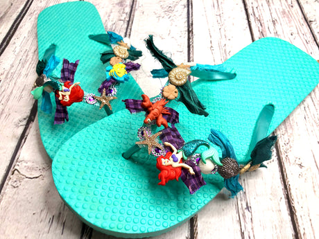 Dress up flip flops with characters from Disney's The Little Mermaid buttons and seashell embellishments