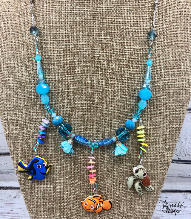 Nemo and friends from the Disney movie adorn this fun necklace 